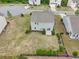 Aerial view of the backyard showing green grass, landscaping, fencing, and the back of the house at 4615 Elmwood Trl, Cumming, GA 30028