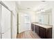 Bathroom featuring dual vanities, wood floors, and a separate shower with glass doors at 4615 Elmwood Trl, Cumming, GA 30028