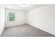 Bedroom featuring carpet floors, a window with blinds, and white walls at 4615 Elmwood Trl, Cumming, GA 30028