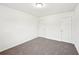 Bedroom featuring carpeted floors and two white paneled doors at 4615 Elmwood Trl, Cumming, GA 30028