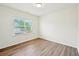 Bright bedroom features wood-look flooring and a window with natural light at 4615 Elmwood Trl, Cumming, GA 30028