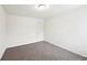 Bright bedroom with carpet floors, white walls, and a paneled door at 4615 Elmwood Trl, Cumming, GA 30028