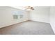 Bright bedroom with two windows, carpet flooring, and a modern ceiling fan for added comfort at 4615 Elmwood Trl, Cumming, GA 30028