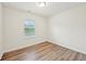 This bedroom features wood-look flooring and a window for natural light at 4615 Elmwood Trl, Cumming, GA 30028