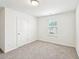Bedroom with carpet floors, a window with blinds, and white walls at 4615 Elmwood Trl, Cumming, GA 30028