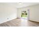 This room features wood-look flooring, natural light, and a sliding glass door to the backyard at 4615 Elmwood Trl, Cumming, GA 30028