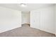 Spacious bedroom featuring carpet floors and multiple doors at 4615 Elmwood Trl, Cumming, GA 30028