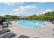 Outdoor community pool with lounge chairs and tables surrounded by a black metal fence at 4615 Elmwood Trl, Cumming, GA 30028