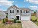 Inviting exterior featuring a driveway and colorful landscaping at 4615 Elmwood Trl, Cumming, GA 30028