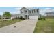 Charming two-story home featuring a wide driveway and manicured front yard with mature landscaping at 4615 Elmwood Trl, Cumming, GA 30028