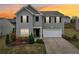 Charming two-story home featuring a well-manicured front yard and an attached two-car garage at 4615 Elmwood Trl, Cumming, GA 30028