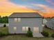 Rear exterior view of a two-story home with neutral siding and a sliding glass door to the patio at 4615 Elmwood Trl, Cumming, GA 30028