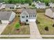 Charming two-story home features a well-manicured lawn and a long, paved driveway to a built-in garage at 4615 Elmwood Trl, Cumming, GA 30028