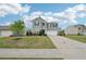 Inviting two-story home with a well-maintained lawn and a concrete driveway leading to an attached garage at 4615 Elmwood Trl, Cumming, GA 30028