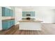 This kitchen features an island, stainless steel appliances, granite countertops and beautiful blue cabinetry at 4615 Elmwood Trl, Cumming, GA 30028