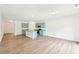 Spacious living room with wood floors, recessed lighting, and adjacent kitchen at 4615 Elmwood Trl, Cumming, GA 30028
