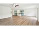Open-concept living space with a modern kitchen and wood-look flooring at 4615 Elmwood Trl, Cumming, GA 30028