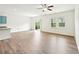 Bright living room with wood floors, ceiling fan, and access to a patio at 4615 Elmwood Trl, Cumming, GA 30028