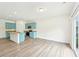 Open-concept living space with a modern kitchen and wood-look flooring at 4615 Elmwood Trl, Cumming, GA 30028