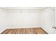 Walk-in closet with wood floor, shelving, and ample storage for clothes and personal items at 4615 Elmwood Trl, Cumming, GA 30028