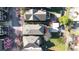 An aerial view of the rooftops of three houses, along with flowering trees and an outdoor patio area at 94 Hogue Ne St, Atlanta, GA 30312