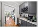 Convenient bar area showcases custom gray cabinets, a wine rack, and sleek countertops, perfect for entertaining at 94 Hogue Ne St, Atlanta, GA 30312