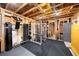 Basement offers a workout area with fitness equipment, weights, and exposed beam ceiling, perfect for a home gym at 94 Hogue Ne St, Atlanta, GA 30312