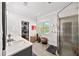 A modern bathroom featuring double sinks, a glass shower, and a walk-in closet at 94 Hogue Ne St, Atlanta, GA 30312