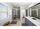 A bright bathroom featuring a glass shower, a vanity with modern fixtures, and a window at 94 Hogue Ne St, Atlanta, GA 30312