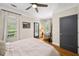 Bright bedroom featuring hardwood floors, a ceiling fan, and a private outdoor access door at 94 Hogue Ne St, Atlanta, GA 30312