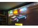 A close up of the projector system shows the race car setup in the garage at 94 Hogue Ne St, Atlanta, GA 30312