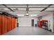 Spacious garage with epoxy floors, recessed lighting, and ample storage and organization with an access door to the home at 94 Hogue Ne St, Atlanta, GA 30312