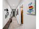 A bright hallway boasts stylish decor, including art and a wooden bench, enhanced by a patterned rug and recessed lighting at 94 Hogue Ne St, Atlanta, GA 30312