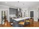 Modern kitchen featuring a center island with barstool seating, stainless steel appliances, and gray cabinetry at 94 Hogue Ne St, Atlanta, GA 30312