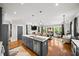 Open-concept kitchen features a spacious island, modern stainless steel appliances, and views into the living space at 94 Hogue Ne St, Atlanta, GA 30312
