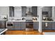 Modern kitchen with stainless steel appliances, gray cabinets, and quartz countertops at 94 Hogue Ne St, Atlanta, GA 30312