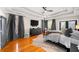 Spacious main bedroom features a tray ceiling, hardwood floors, and large windows with elegant drapery at 94 Hogue Ne St, Atlanta, GA 30312