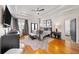 Luxurious main bedroom features a tray ceiling, hardwood floors, and a cozy seating area with ample natural light at 94 Hogue Ne St, Atlanta, GA 30312