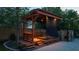 Wooden backyard pergola with bar and shade, offering a stylish and private outdoor space at 94 Hogue Ne St, Atlanta, GA 30312