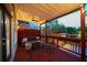 Cozy covered porch with dark wood floors, ceiling fan, seating, and outdoor lighting at 94 Hogue Ne St, Atlanta, GA 30312