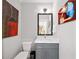 Stylish powder room features a modern vanity, decorative mirror, and contemporary artwork for added charm at 94 Hogue Ne St, Atlanta, GA 30312