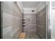 A walk-in shower with neutral tile, a built-in niche, and a wooden bench at 94 Hogue Ne St, Atlanta, GA 30312