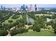 An aerial view of a park in the city with a pond surrounded by green trees and a cityscape in the background at 1026 Reeder Cir, Atlanta, GA 30306