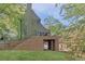 An expansive backyard featuring a brick patio, a grassy lawn, and natural landscaping at 1026 Reeder Cir, Atlanta, GA 30306