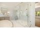 Bathroom with marble floors, walk-in glass shower, soaking tub, double vanity, and modern fixtures at 1026 Reeder Cir, Atlanta, GA 30306