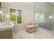 Bathroom with marble floors, walk-in glass shower, soaking tub, double vanity, and large window views at 1026 Reeder Cir, Atlanta, GA 30306