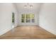 Light-filled bedroom boasts hardwood floors and large windows with outdoor views at 1026 Reeder Cir, Atlanta, GA 30306