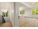Bright room with hardwood floors, and a decorative chandelier, viewed from landing with iron railing and windows at 1026 Reeder Cir, Atlanta, GA 30306