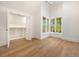 Bedroom features closet, hardwood floors, and large windows with outdoor views at 1026 Reeder Cir, Atlanta, GA 30306