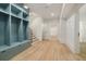 A long hallway with light-colored wood floors leads to a staircase and several doorways at 1026 Reeder Cir, Atlanta, GA 30306